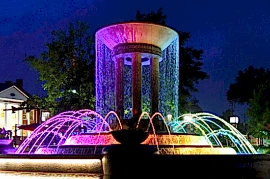 Colorful water fountain at dusk in downtown Cary, North Carolina.